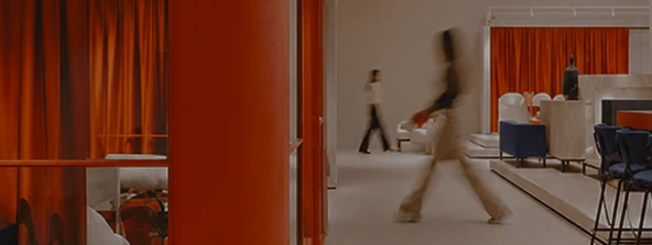 An office with a red-panelled meeting room and a counter